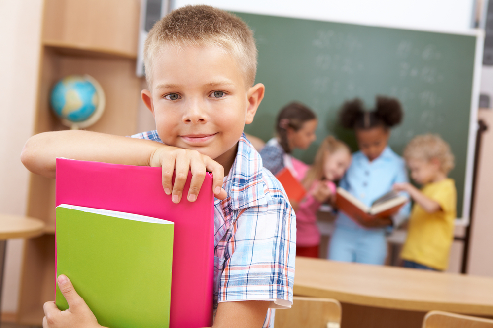 boy holding books